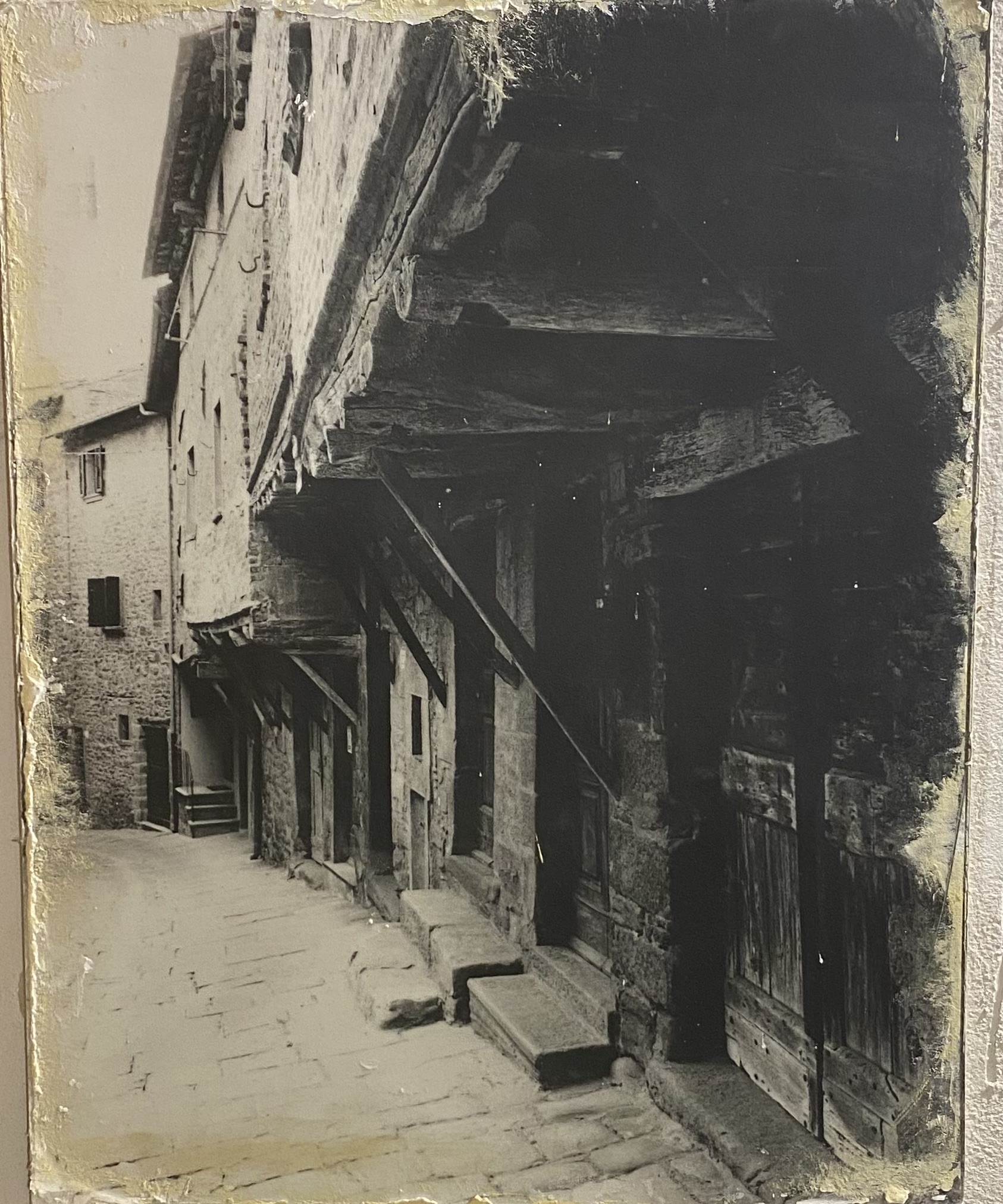Cortona for first-timers — medieval Via Janelli with overhanging houses, Cortona, Tuscany
